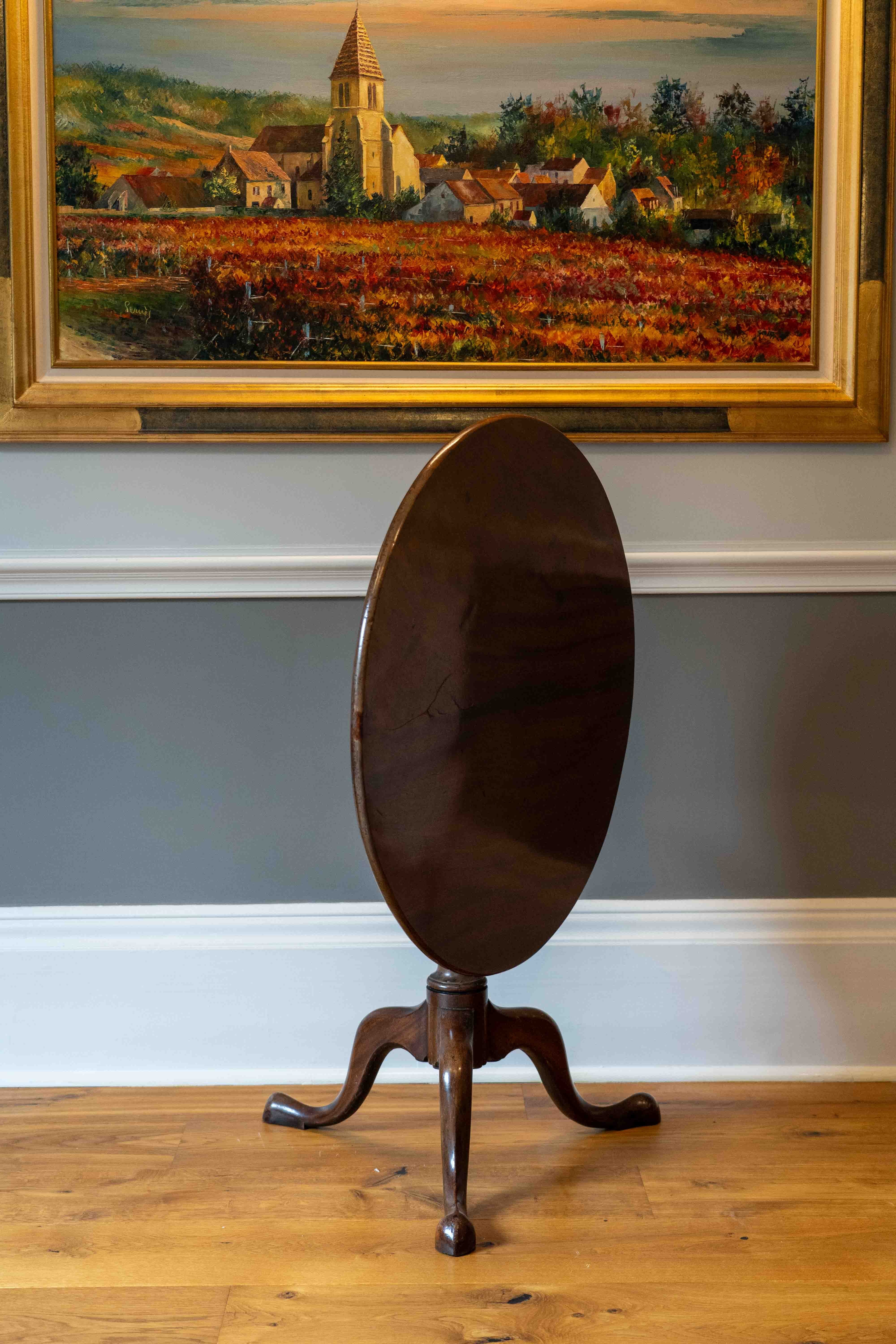 A George III circular mahogany tilt top tripod table, diameter 82cm, height 70cm. Condition - fair